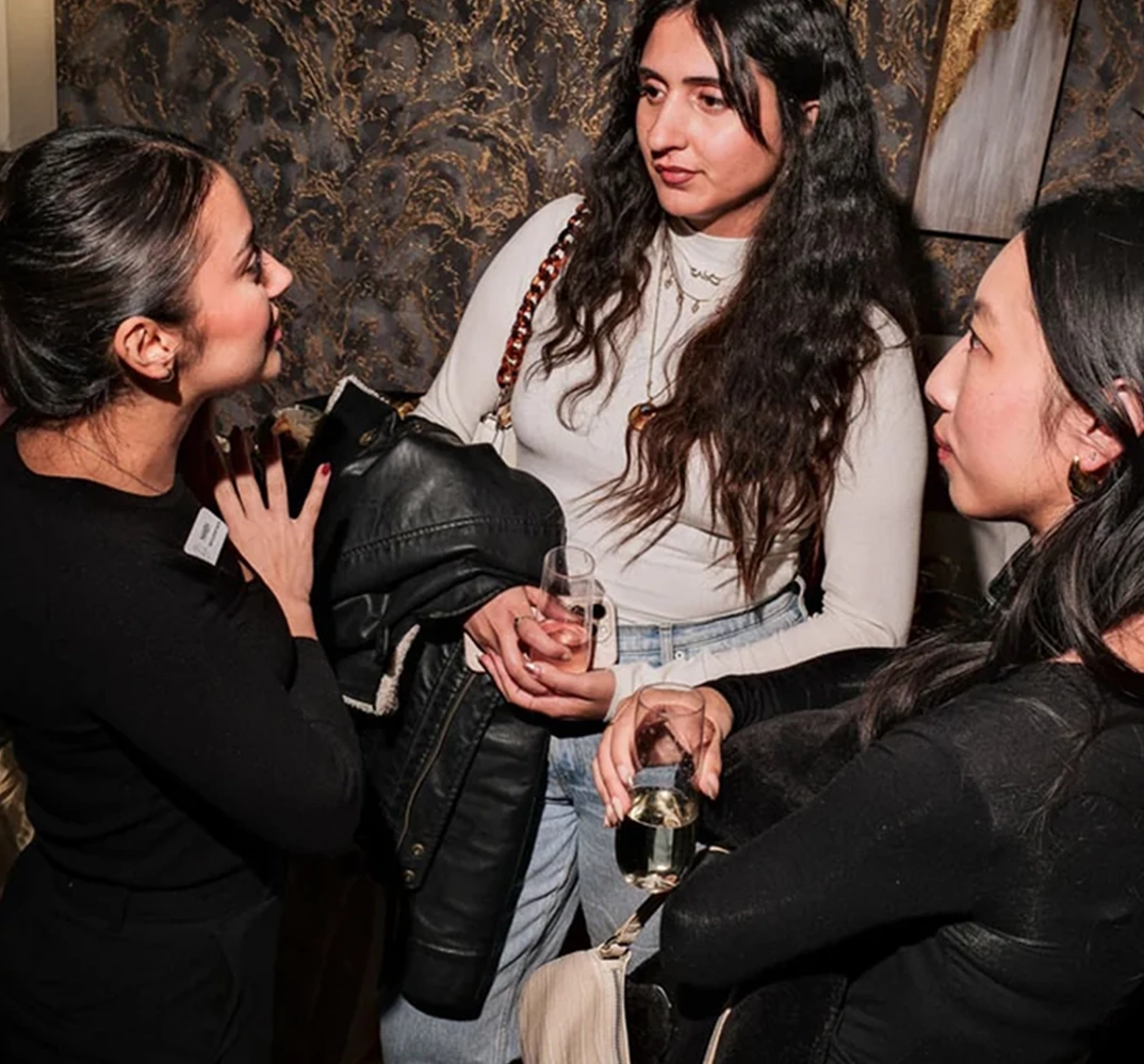 Three women conversing at event