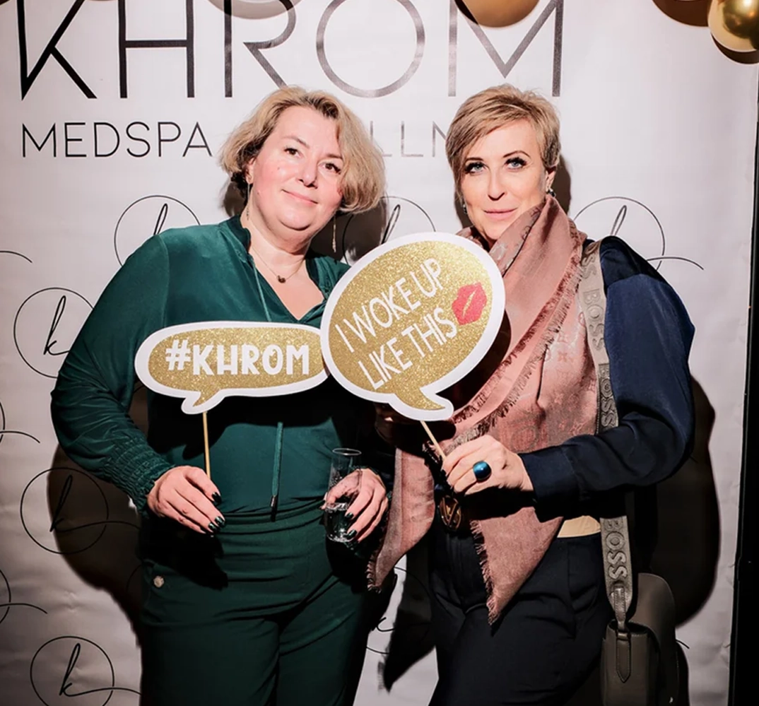 Two women holding fun signs