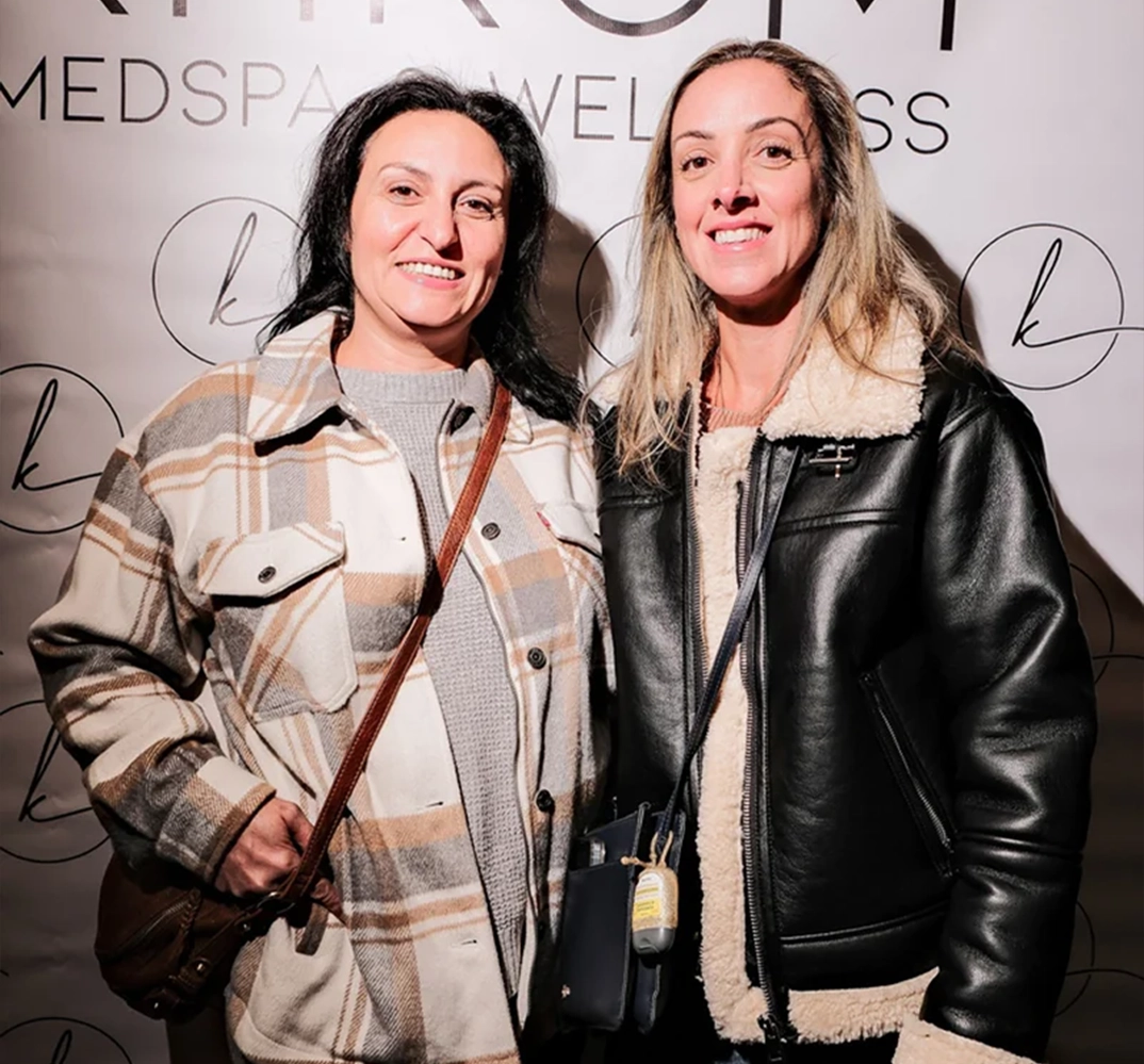 Two women posing together smiling